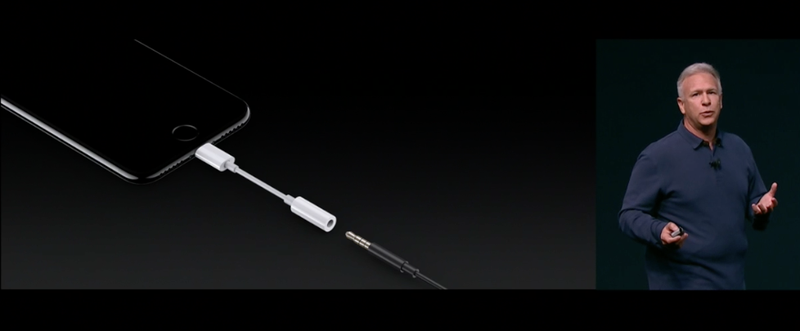 Apple executive Phil Schiller talks about his dongle, necessitated by Apple’s enormous boner. (Screenshot: Apple)